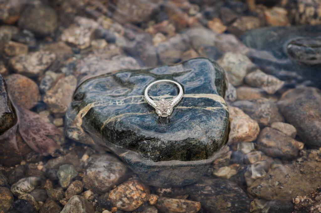 Engagement ring sitting on a rock