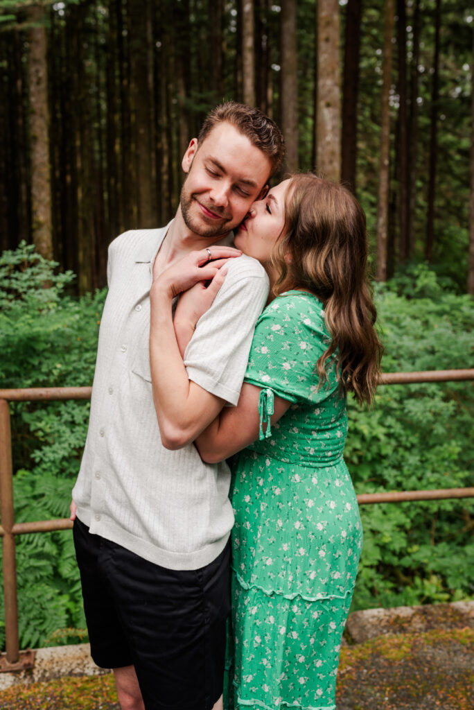 Girl kisses guys cheek and holding each other closely