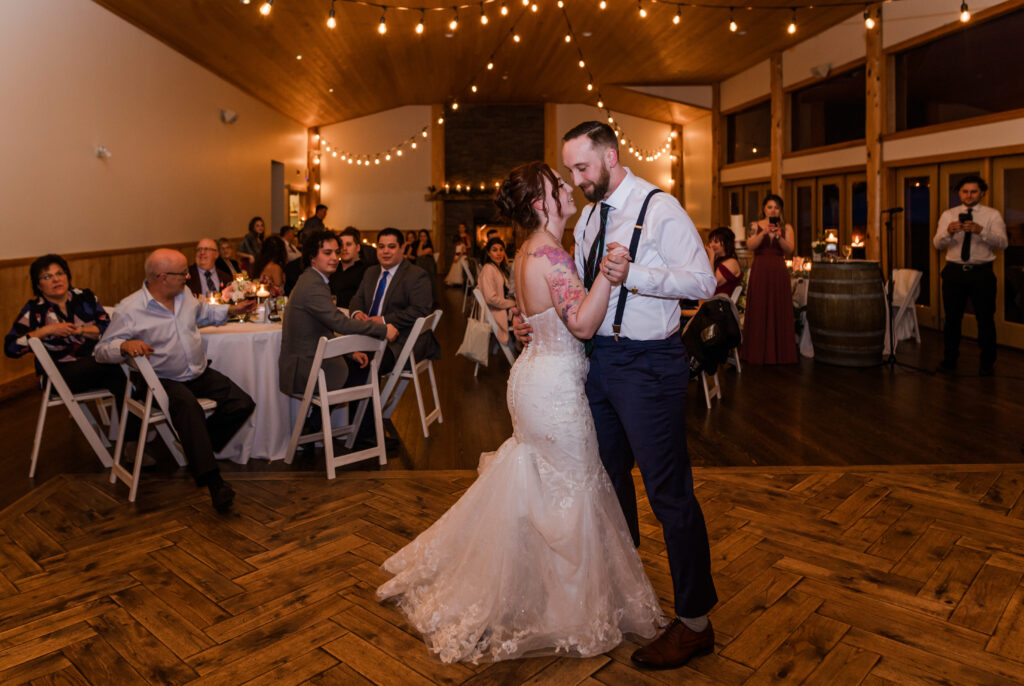 First dance of bride and groom at Fraser River Hall, guests watching in the back round.
