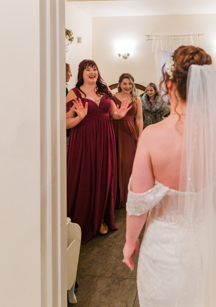 Bridesmaid is surprised to see her best friend in her wedding dress.