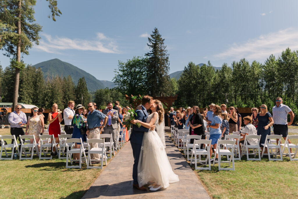 bride-and-groom-dip-down-for-a-romantic-kiss-at-ceremony.