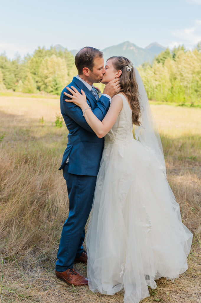 bride-and-groom-embrace-for-a-kiss-on-their-wedding-day.
