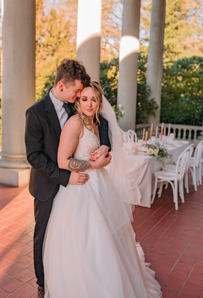 Bride and groom snuggling before reception time at Hycoft Manor. couples eyes are closed. 