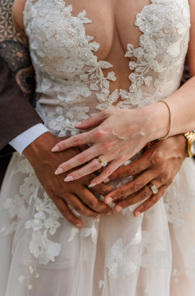 Wedding day detail shoots of dress, wedding rings, watch and bracelet. 