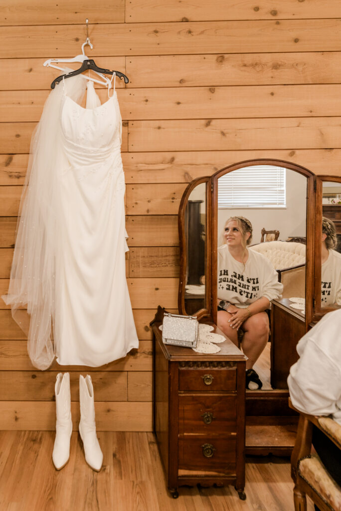Langley BC Wedding at Loft Country bride looking at her dress before putting it on.