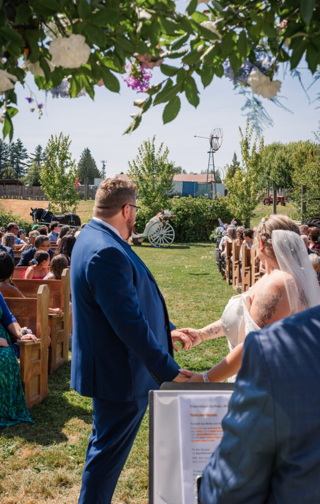 Ceremony Langley BC Wedding at Loft Country with a hawk flying down. Bride and groom watching it fly down the aisle. 