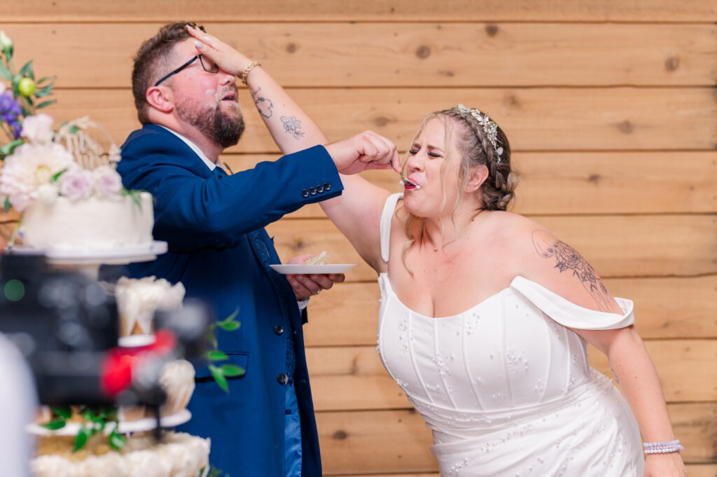 Langley Wedding at Loft Country reception cake cutting and bride getting the groom with the cake.